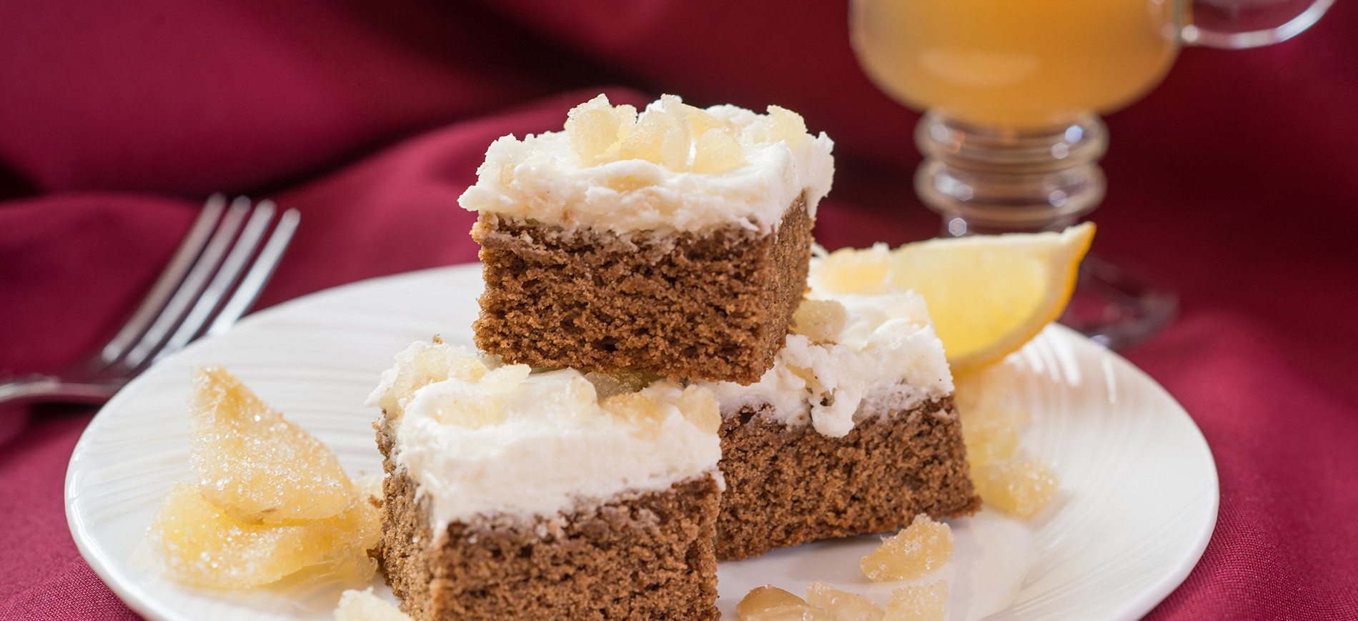 Gingerbread bars on white plate and red tablecloth
