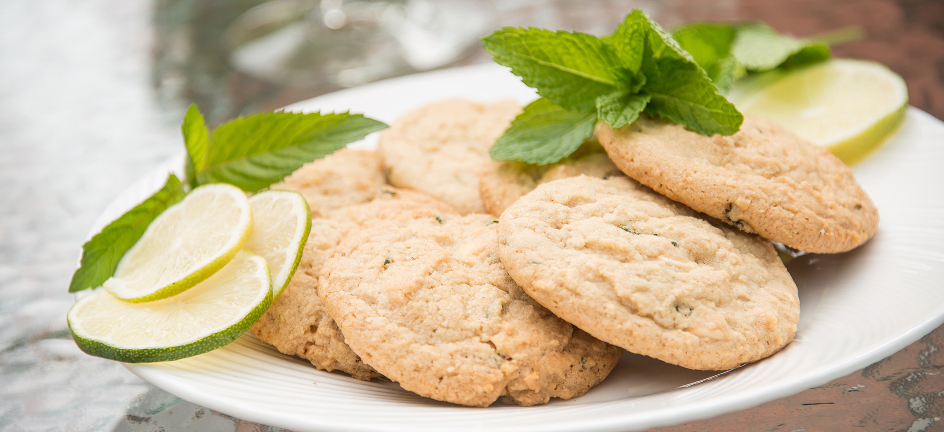Mojitoo Cookies on white plate with mint & lime slice garnish