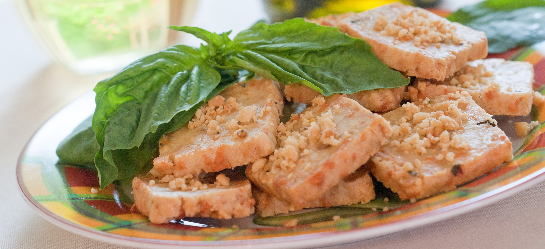 Pignoli Bite cookies on plate with basil garnish