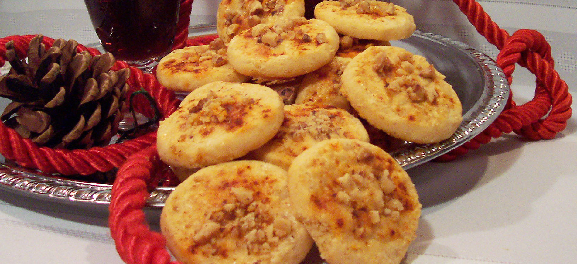 Chipotle Cheddar Savory Shortbreads on silver tray with red roping & pinecone