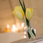 vase of yellow tulips and votive candles