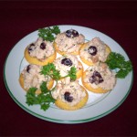 turkey terrine on butter crackers with parsley garnish