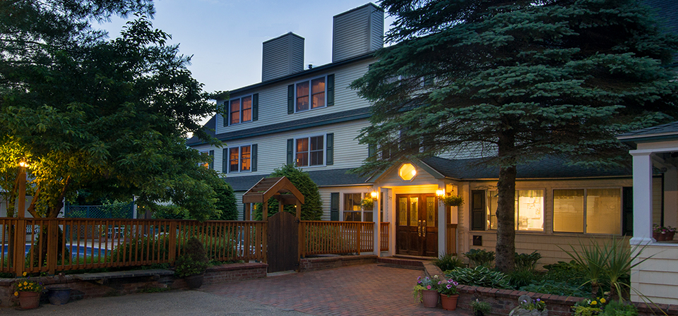 Inn at Ellis River entrance at dusk in summer