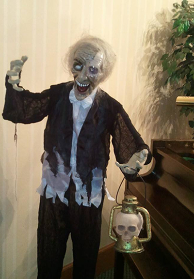 Vinney the Ghoul standing next to piano