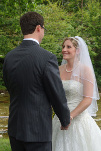 Groom & Bride holding hands by Ellis River