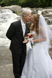 bride & groom kissing at waterfall