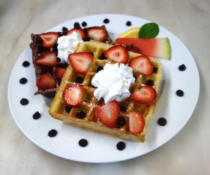 Chocolate and Plain waffles with strawberries and whipped cream